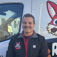 Ed, Red Fox Electric Service Technician, Smiling In Branded Uniform Beside Company Van In Denver, CO.