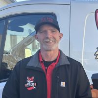 Tim, Red Fox Electric Service Technician, Smiling In Uniform And Hat Beside Branded Service Van In Denver, CO.