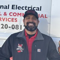 Robert, Red Fox Electric Service Manager, Smiling In Branded Uniform And Hat In Front Of Company Van In Denver, CO.